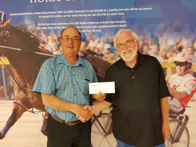 ed siefried receives cheque from Woolwich ag society